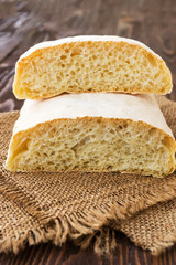Ciabatta on a burlap on wooden table