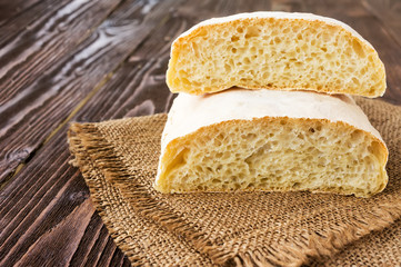 Ciabatta on a burlap on wooden table