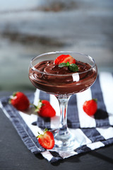 Chocolate mousse with fresh berries on wooden background
