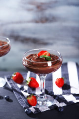 Chocolate mousse with fresh berries on wooden background
