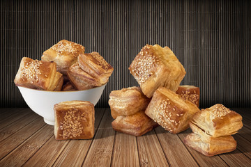 Bunch of Zuzu Square Puff Croissant Pastry on Bamboo Place Mat Background.