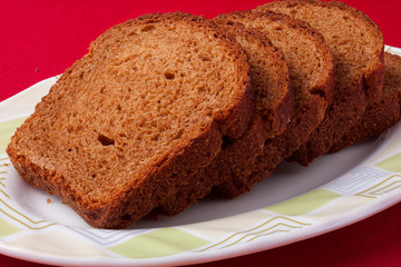 wheat brown bread slices on white background
