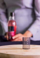 pouring red liquid in beaker on chopping board