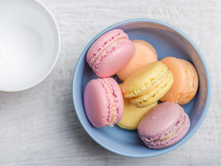 Colorful macarons on vintage pastel background