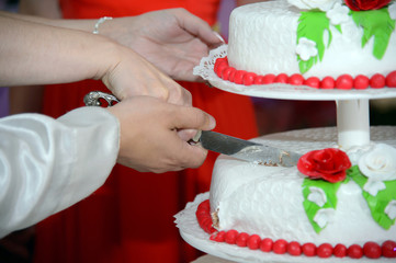 Cutting of the cake. Birthday cake. A piece of cake with cream and berries. A delicious sweet dish. Wedding cake.