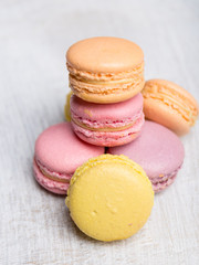 Colorful macarons on vintage pastel background