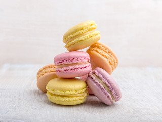 Colorful macarons on vintage pastel background
