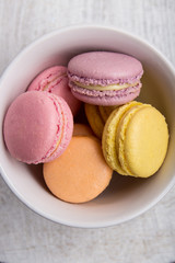 Colorful macarons on vintage pastel background