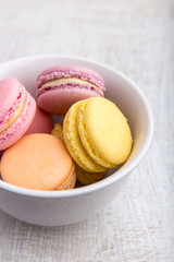 Colorful macarons on vintage pastel background