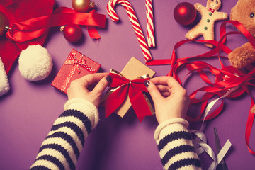 Female hands wrapping a gift
