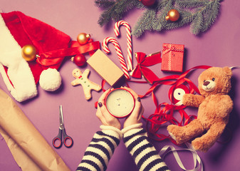 hands holding a cup and cookie