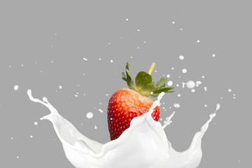 Milk Splash With Strawberry On Blue Background