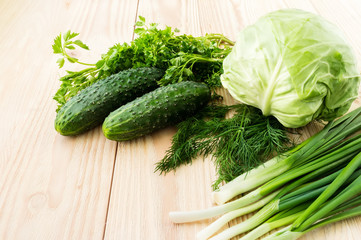 Fresh green vegetables on wooden table