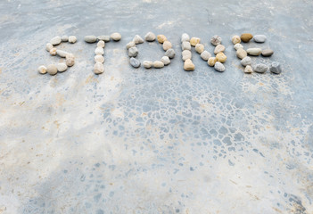 Closeup text by stone on old concrete floor texture background