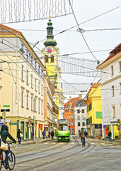 Street view to Stadtpfarrkirche and a tram and bicycles in Graz