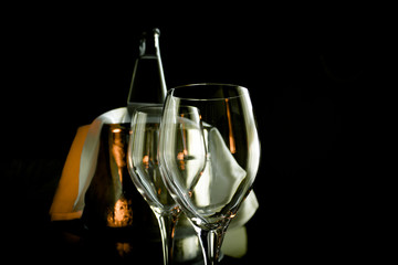 Two empty wine glasses and ice bucket