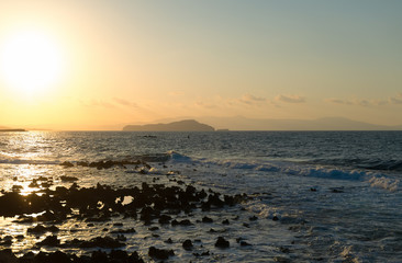 Fototapeta premium Sunset on the rocky beach in Mediterranean sea.