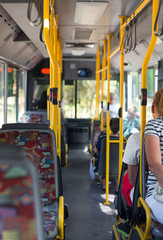View from inside the city bus with passengers.