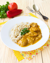Chicken cooked in paprika and cream sauce, served with rice, wit