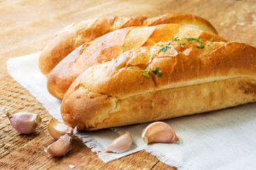 Three tasty baguettes on rustic wooden countertop