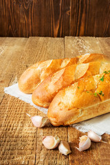 Three french baguettes on wooden background