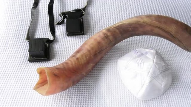 Shofar (horn) with Tefillin and Yamaka on Rosh Hashanah and Yom Kippur High Holidays. Traditional Jewish holiday symbol. Concept with copy space