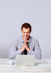 Happy man working on laptop in the office