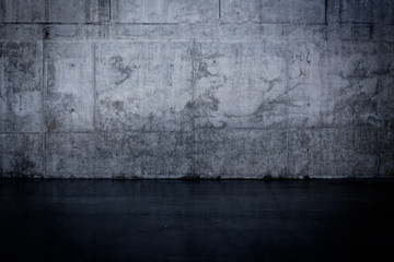 Grungy dark concrete wall and wet floor