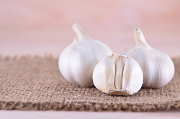 Garlic on sack with wooden background