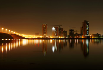 Naklejka premium A beautiful view of Bahrain skyline during night and its reflect
