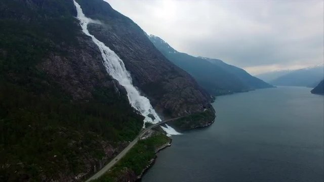 Aerial footage of massive waterfall Langfossen falling down to fjord below. Aerial 4k Ultra HD.
