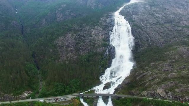 Aerial footage of Langfossen waterfall in Norway and road bridge with cars passing above the waterfall. Aerial 4k Ultra HD.