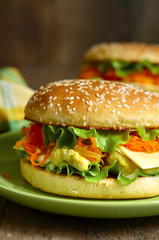 Homemade burger with chicken,cheese an spicy carrot.