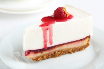 Fresh raspberry cheesecake on white plate