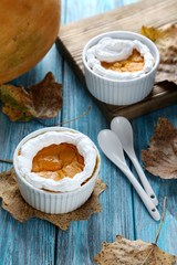 Tasty pumpkin pie in bowl on a blue wooden table