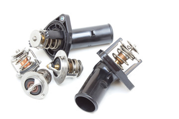 Parts of the car engine. Thermostat engine cooling system of the internal combustion machine. Spare parts on a white background