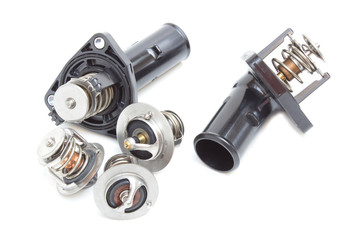 Parts of the car engine. Thermostat engine cooling system of the internal combustion machine. Spare parts on a white background
