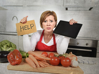 inexperienced home cook woman in red apron screaming desperate and frustrated at domestic kitchen...