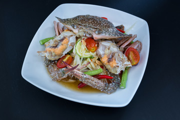 papaya salad with crab on black background