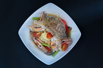 papaya salad with crab on black background