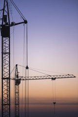 Tower crane on the sunset sky background
