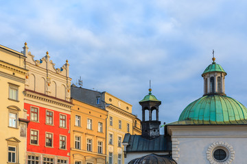 Obraz premium Colourful houses and church building on market square in Krakow, Poland