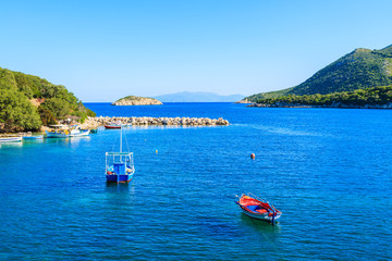Fototapeta na wymiar Colorful fishing boats on blue sea, Kefalonia island, Greece