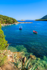 Fishing boats on blue sea in mountain landscape of Kefalonia island, Greece