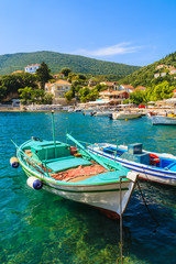 Fishing boats on turquoise sea water in Kioni port, Ithaka island, Greece