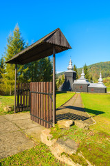 Gate to old wooden orthodox catholic church in Czarna village on sunny autumn day, Beskid Niski Mountains, Poland
