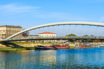 Bernatka bridge over Vistula river on sunny autumn day in city of Krakow, Poland