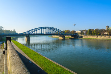 Fototapeta premium Bridge over Vistula river on sunny autumn day in city of Krakow, Poland