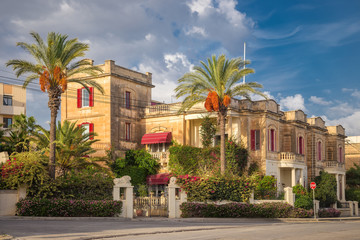 Fototapeta na wymiar Nice traditional building at Valletta with palm trees - Malta