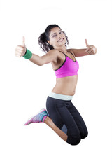 Indian woman jumping and shows thumbs up